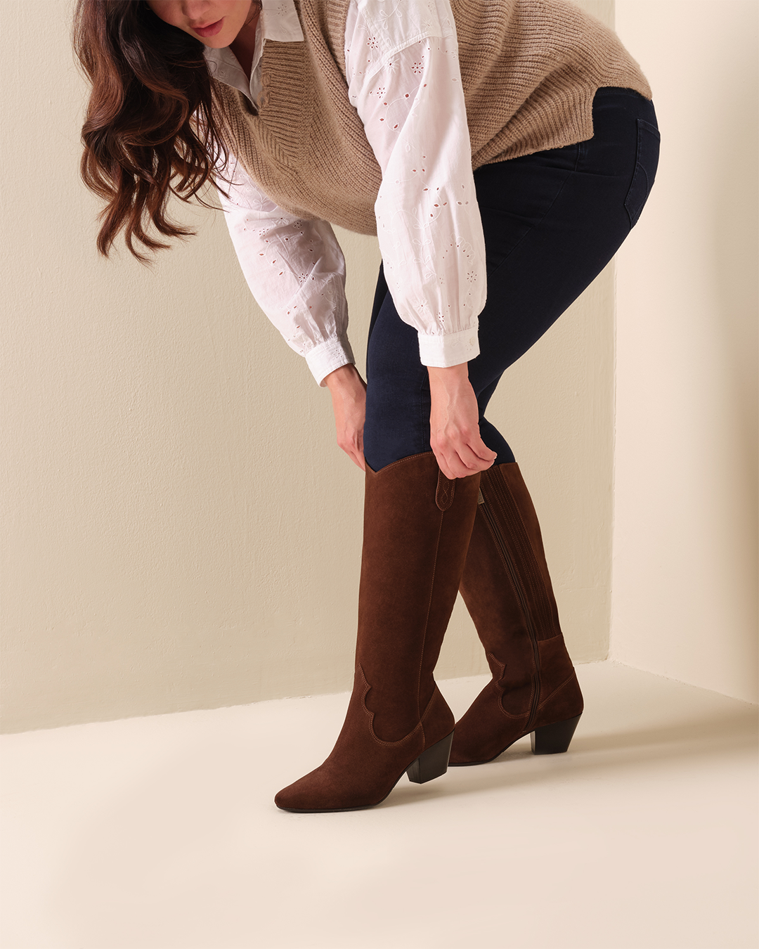 woman wearing knee high brown suede western boots